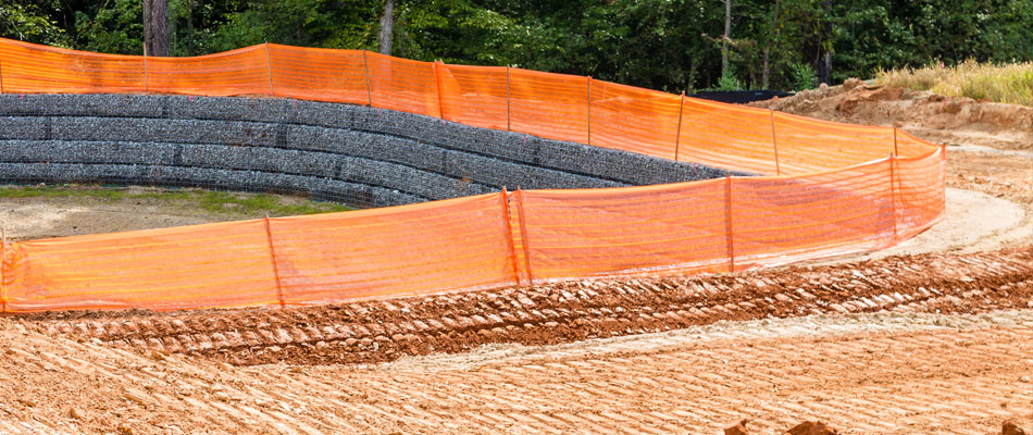 Bright orange high visibility barrier that clearly identifies an area to avoid at a construction site in Spring Hill.